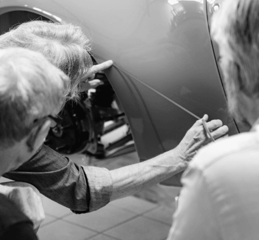 Two REEN engineers examining the bodywork up close